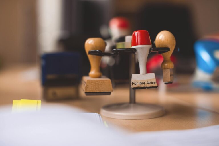 A variety of rubber stamps in selective focus on a wooden table indoors.